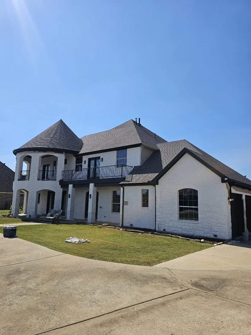 White painted brick exterior with black trim, finished